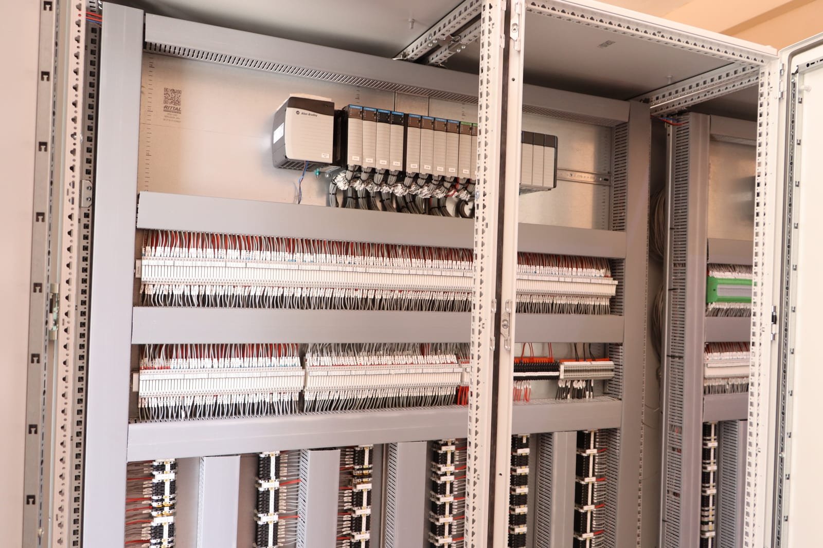 Rittal enclosure interior with an Allen-Bradley PLC and numbered terminal wiring
