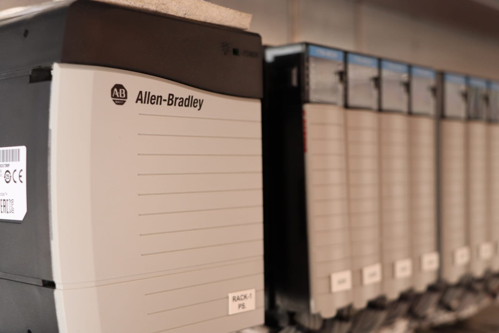 Allen-Bradley PLC rack and I/O modules on a control panel backplate