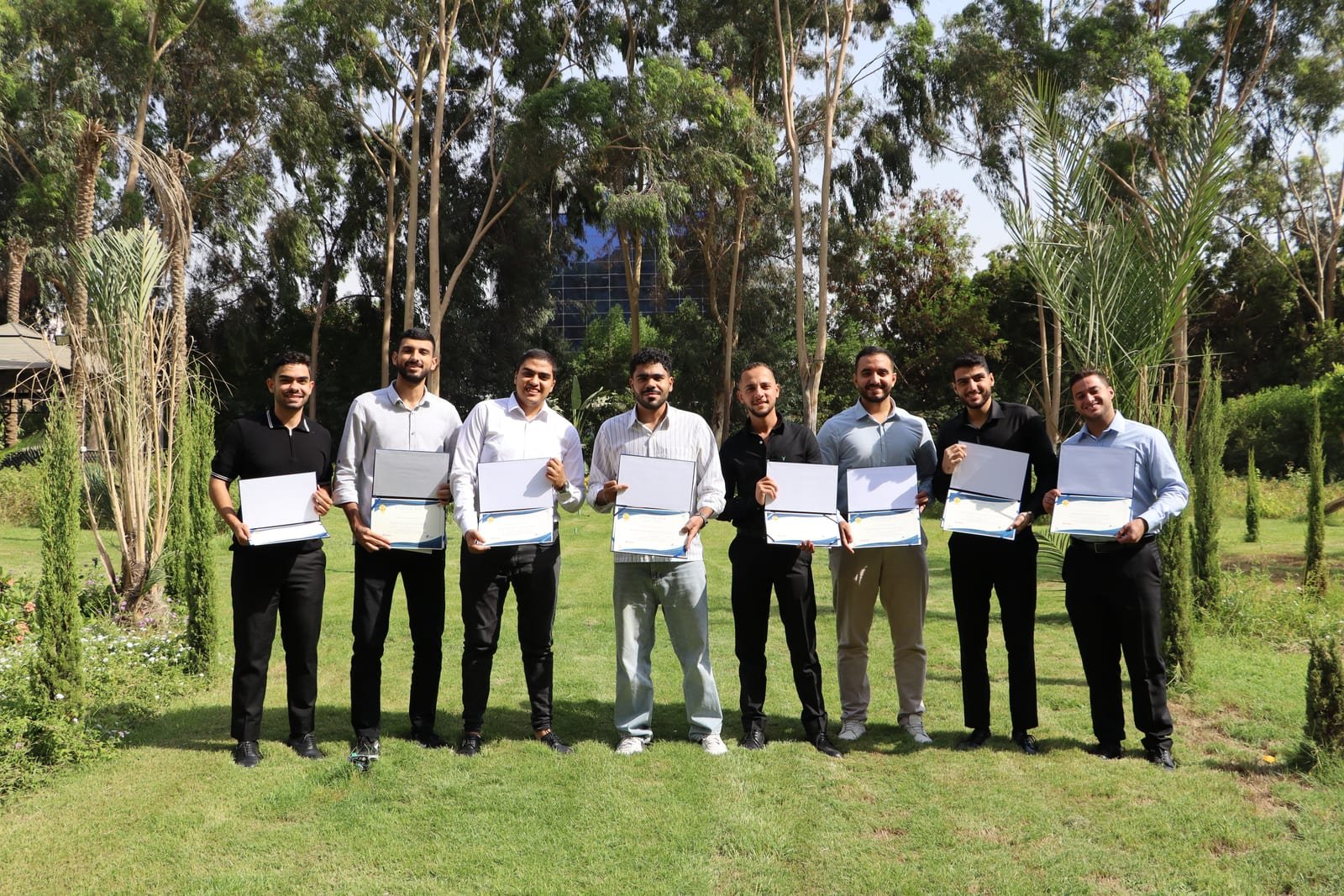 Summer interns with their completion certificates in the garden at the KMT premises
